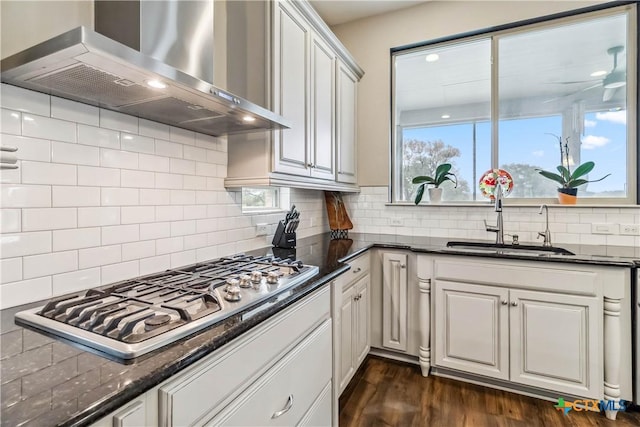 1404 Andalucia Dr, San Marcos, TX 78666 - kitchen featuring wall chimney exhaust hood, stainless steel gas stovetop, a sink, dark wood-style floors, and tasteful backsplash
