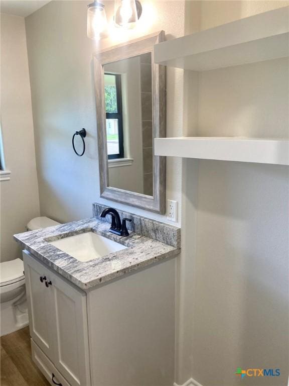 1502 Bowie Dr, Victoria, TX 77901 - half bathroom featuring vanity and wood finished floors