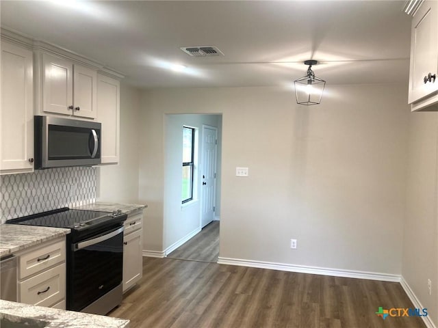 1502 Bowie Dr, Victoria, TX 77901 - kitchen with stainless steel appliances, dark wood-style floors, tasteful backsplash, light stone counters, and white cabinetry