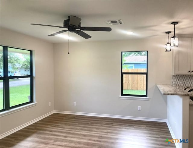1502 Bowie Dr, Victoria, TX 77901 - unfurnished dining area featuring healthy amount of natural light, wood finished floors, and ceiling fan