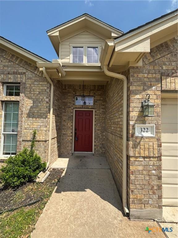 322 Lone Star Blvd, Hutto, TX 78634 - view of exterior entry featuring brick siding