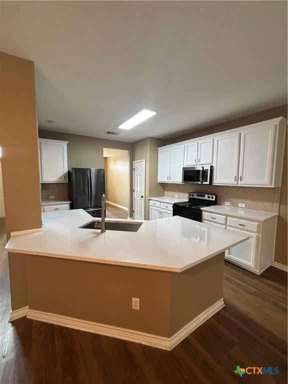 322 Lone Star Blvd, Hutto, TX 78634 - kitchen with electric stove, freestanding refrigerator, a sink, stainless steel microwave, and dark wood finished floors