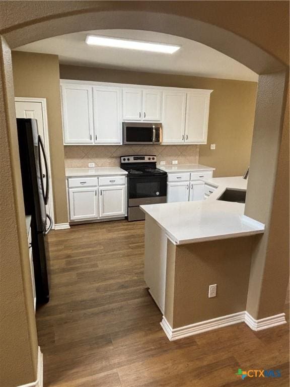 322 Lone Star Blvd, Hutto, TX 78634 - kitchen with appliances with stainless steel finishes, a sink, arched walkways, and light countertops