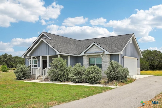 view of front of house with a front yard and a garage