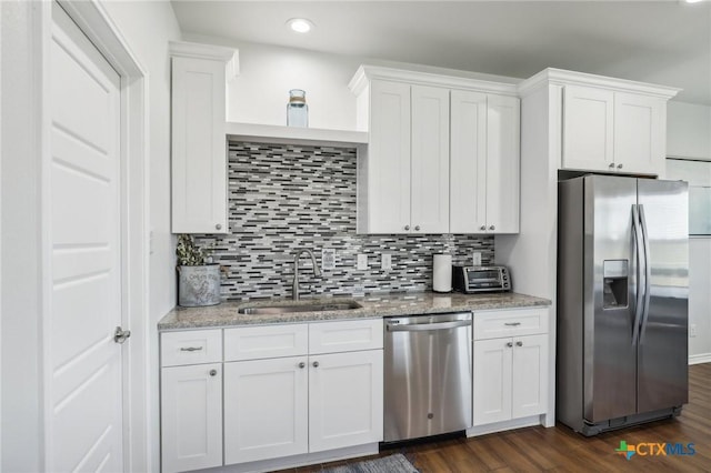 kitchen featuring stainless steel appliances, white cabinetry, sink, and dark hardwood / wood-style floors