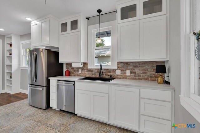 8 Herry Ct, New Braunfels, TX 78130 - kitchen featuring appliances with stainless steel finishes, a sink, white cabinetry, decorative backsplash, and recessed lighting