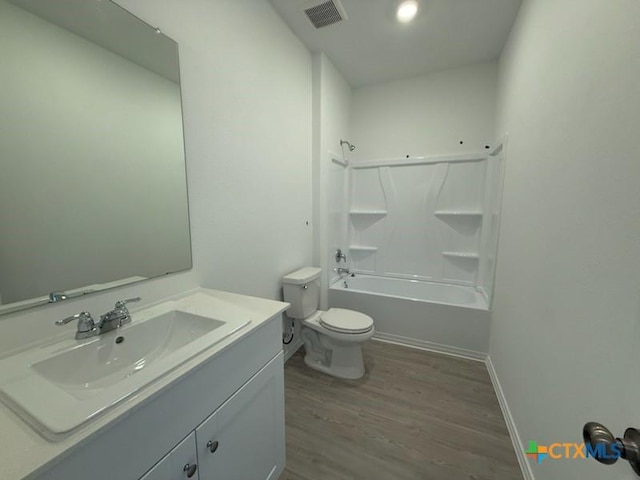 full bathroom featuring hardwood / wood-style floors, vanity, toilet, and tub / shower combination