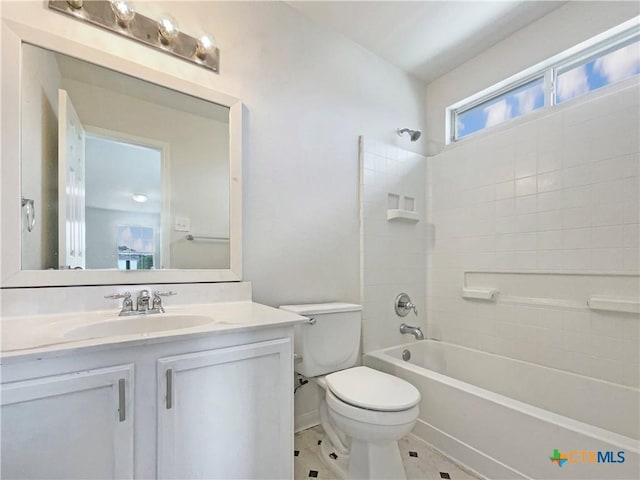 bathroom with toilet, tile patterned flooring,  shower combination, and vanity