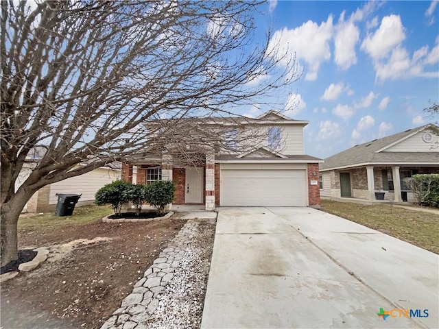 traditional-style house featuring concrete driveway, brick siding, and an attached garage