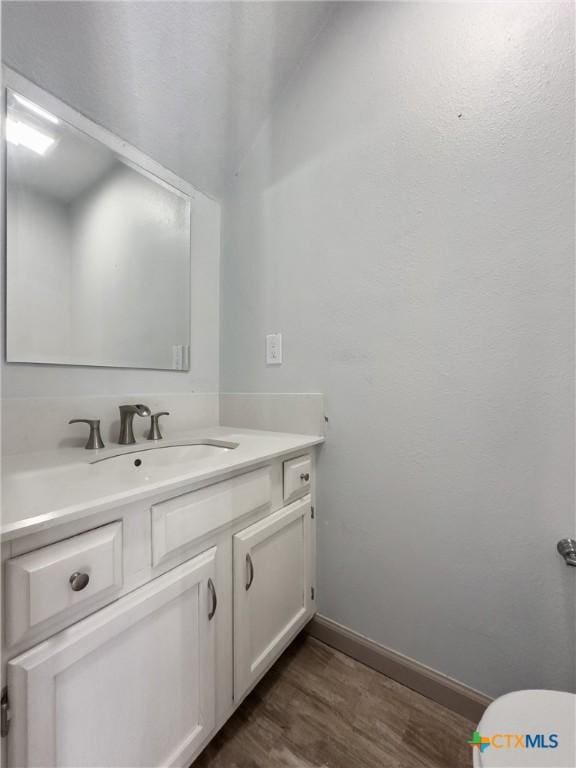 bathroom featuring vanity and hardwood / wood-style floors