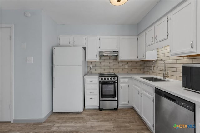 kitchen with white cabinetry, sink, light wood-type flooring, and appliances with stainless steel finishes