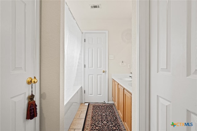 bathroom with vanity and tile patterned floors