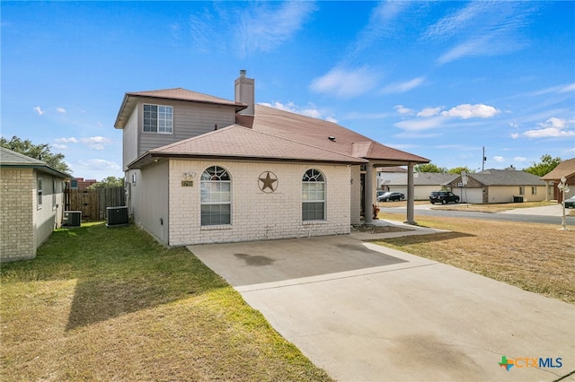 back of property featuring a yard and cooling unit