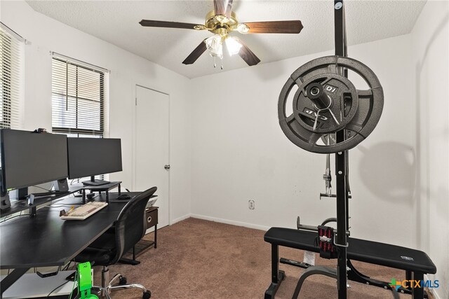 carpeted office featuring a textured ceiling and ceiling fan