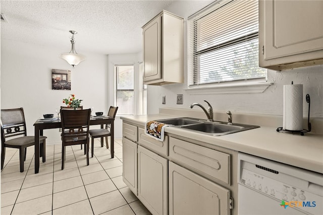 401 Suzie St, Killeen, TX 76542 - kitchen with white dishwasher, light tile patterned flooring, light countertops, pendant lighting, and a textured ceiling