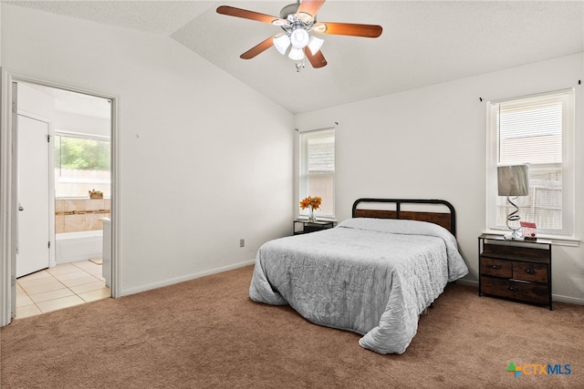 carpeted bedroom with ceiling fan, connected bathroom, and vaulted ceiling