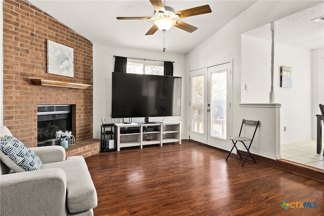 401 Suzie St, Killeen, TX 76542 - living area featuring wood finished floors, a textured ceiling, a ceiling fan, french doors, and a fireplace