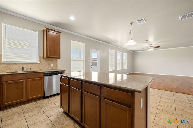 2523 Red Fern Dr, Harker Heights, TX 76548 - kitchen featuring stainless steel dishwasher, ornamental molding, light tile patterned flooring, a center island, and tasteful backsplash