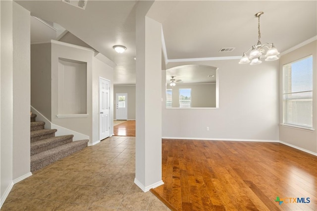 2523 Red Fern Dr, Harker Heights, TX 76548 - entrance foyer featuring ornamental molding, a chandelier, a ceiling fan, stairs, and arched walkways