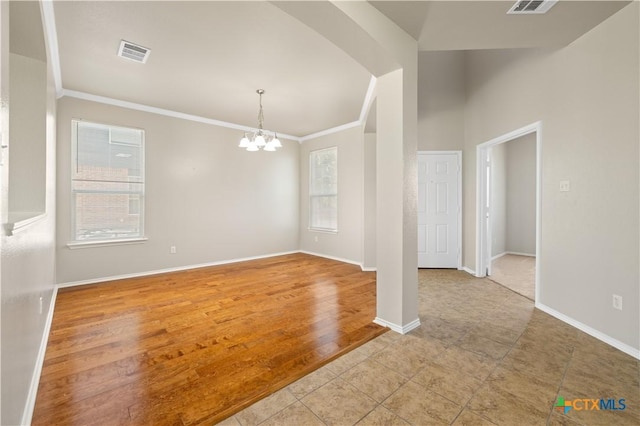 2523 Red Fern Dr, Harker Heights, TX 76548 - empty room with a chandelier, ornamental molding, and arched walkways