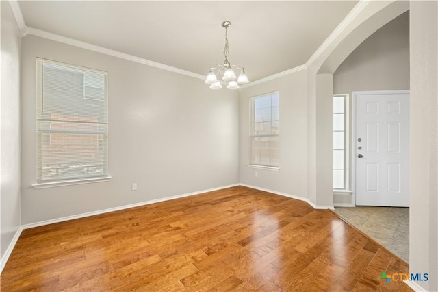 2523 Red Fern Dr, Harker Heights, TX 76548 - spare room with crown molding, a chandelier, arched walkways, and wood finished floors