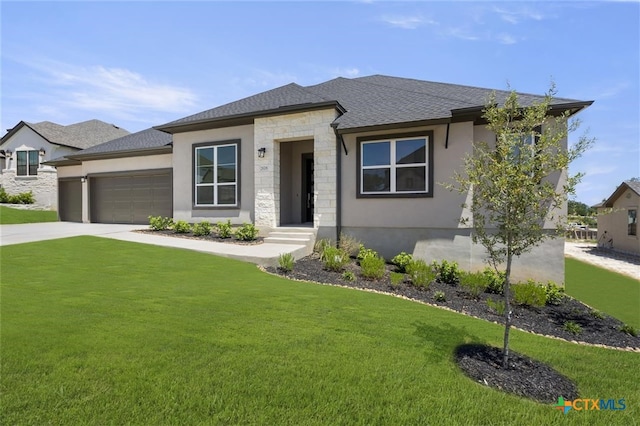 prairie-style home with a front lawn and a garage