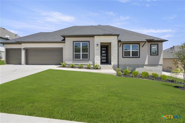 prairie-style house with a garage and a front yard