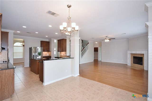 2009 Sandy Point Rd, Harker Heights, TX 76548 - kitchen with stainless steel fridge with ice dispenser, a chandelier, crown molding, a ceiling fan, and dark countertops