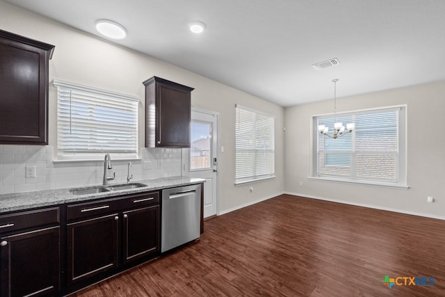 kitchen with dark brown cabinetry, a sink, visible vents, dishwasher, and decorative light fixtures