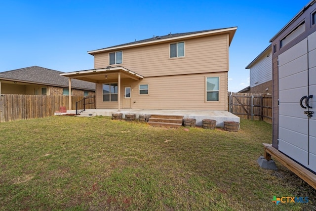 rear view of house with a yard, a patio area, and a fenced backyard