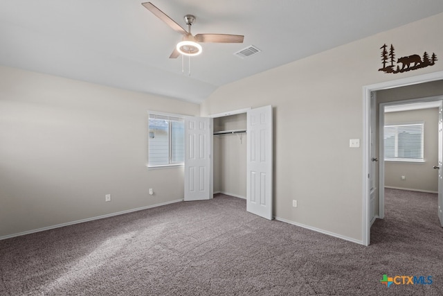 unfurnished bedroom with lofted ceiling, baseboards, visible vents, and carpet flooring