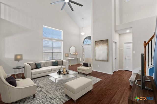 living room featuring stairway, dark wood-style flooring, a ceiling fan, and baseboards