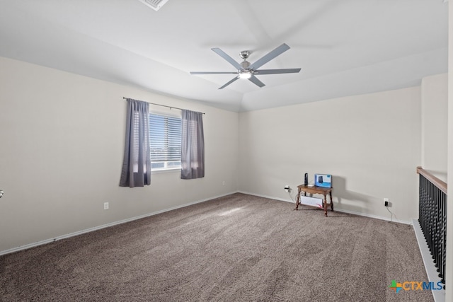 spare room with ceiling fan, carpet, baseboards, and vaulted ceiling