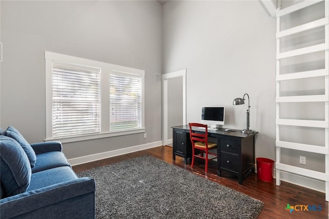 office space with dark wood-type flooring