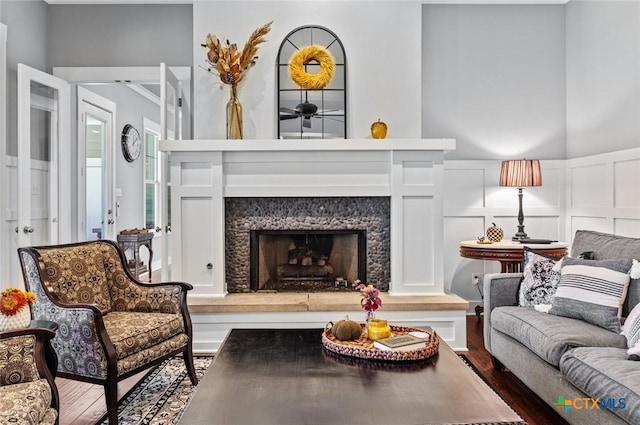 living room featuring a premium fireplace and hardwood / wood-style flooring