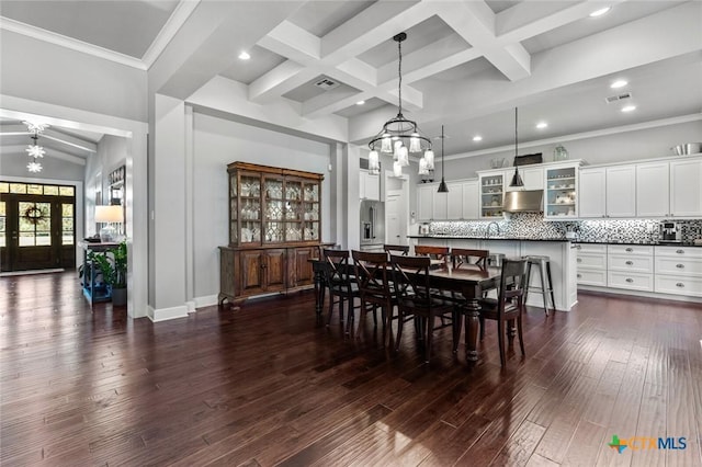 dining room with beamed ceiling, dark hardwood / wood-style floors, ornamental molding, ceiling fan, and coffered ceiling