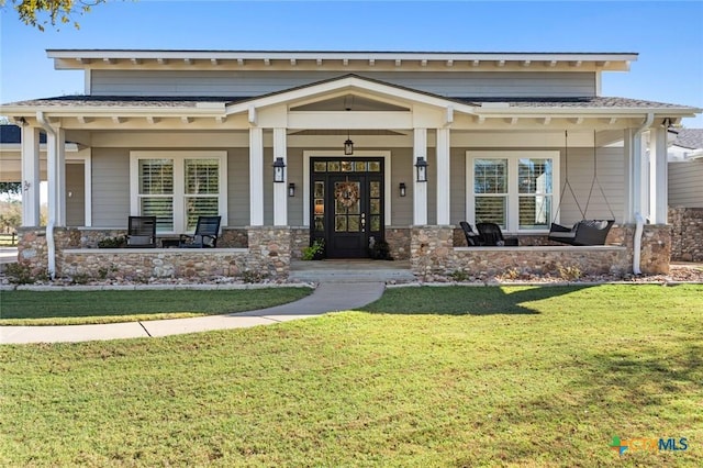 craftsman house with covered porch, french doors, and a front lawn