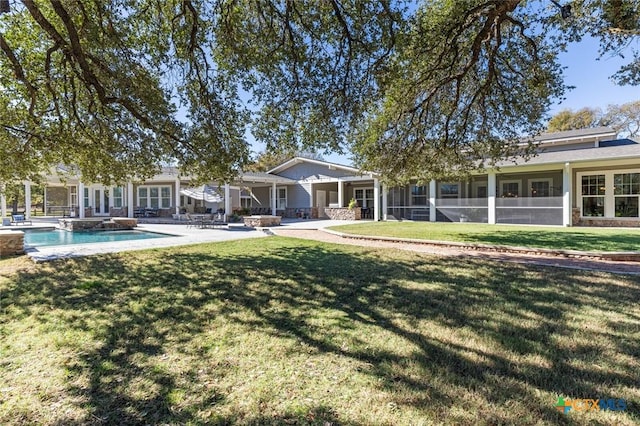 rear view of house with a lawn and a patio