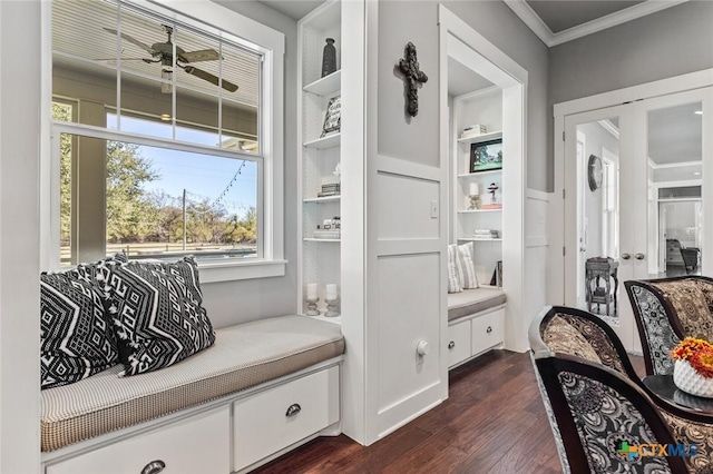 living area featuring dark wood-type flooring, built in features, crown molding, and french doors