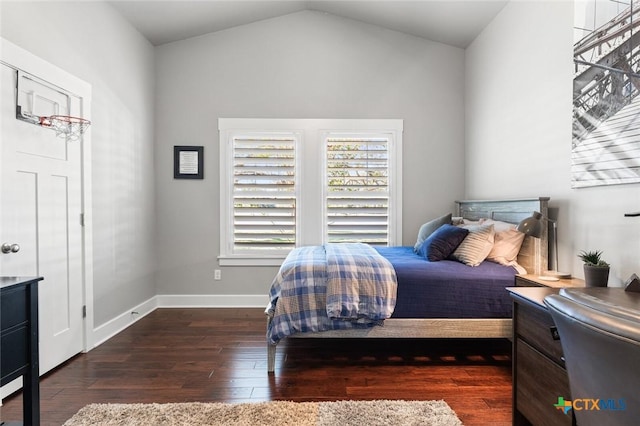 bedroom featuring dark wood-type flooring and vaulted ceiling