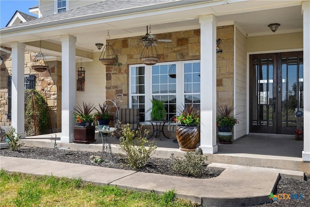 428 Colorado Dr, Cedar Creek, TX 78612 - view of exterior entry featuring stone siding, french doors, covered porch, roof with shingles, and a ceiling fan