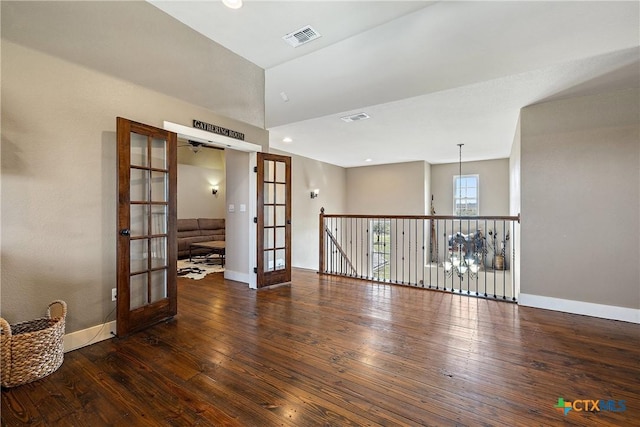 428 Colorado Dr, Cedar Creek, TX 78612 - empty room with french doors, baseboards, hardwood / wood-style flooring, recessed lighting, and a towering ceiling