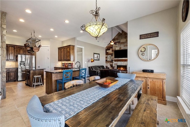 428 Colorado Dr, Cedar Creek, TX 78612 - dining space with a stone fireplace, ceiling fan, recessed lighting, baseboards, and light tile patterned floors