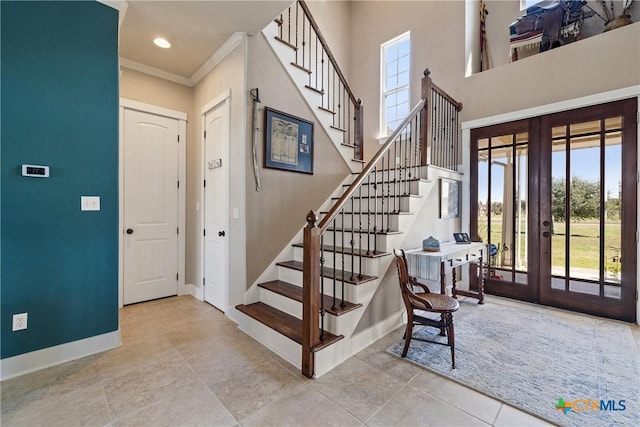 428 Colorado Dr, Cedar Creek, TX 78612 - tiled entrance foyer with french doors, baseboards, crown molding, and stairway