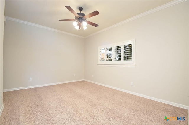 carpeted empty room featuring ceiling fan and ornamental molding