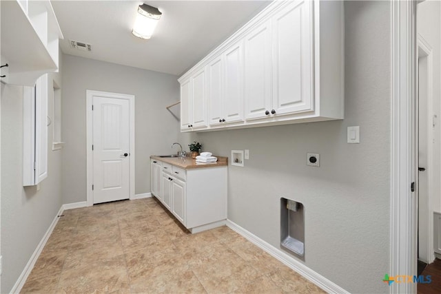 laundry area featuring sink, cabinets, hookup for a washing machine, and electric dryer hookup