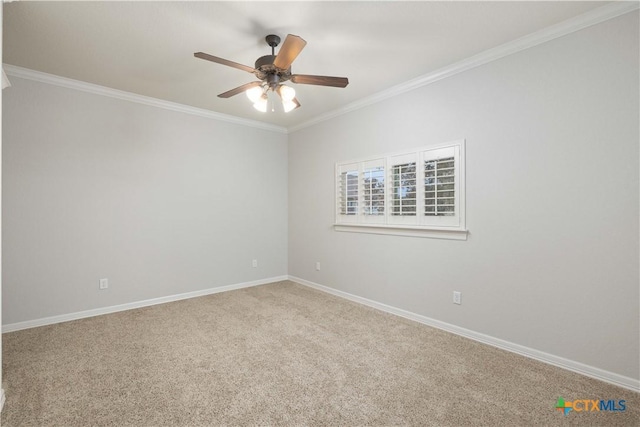 empty room with ceiling fan, crown molding, and carpet flooring