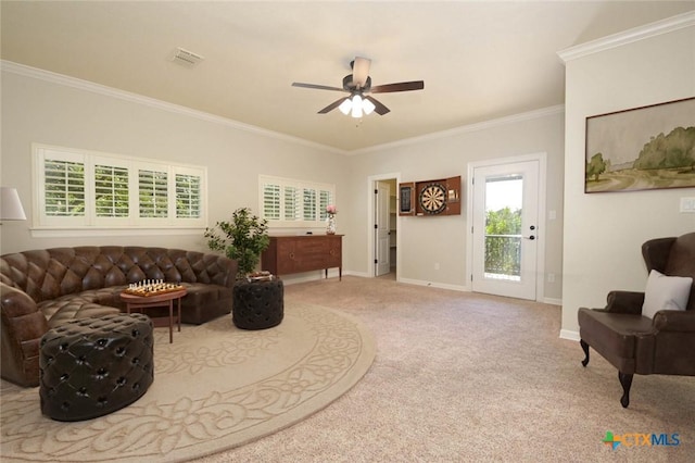 living room featuring ceiling fan, ornamental molding, and carpet flooring