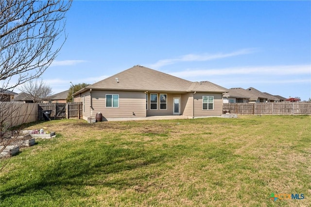 back of property featuring a lawn and a patio