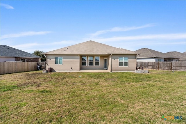 rear view of house featuring a yard and a patio